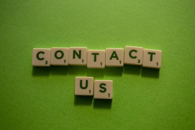 Text tiles spelling "CONTACT US" on a green background.